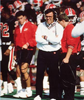 A group of men standing on top of a football field.