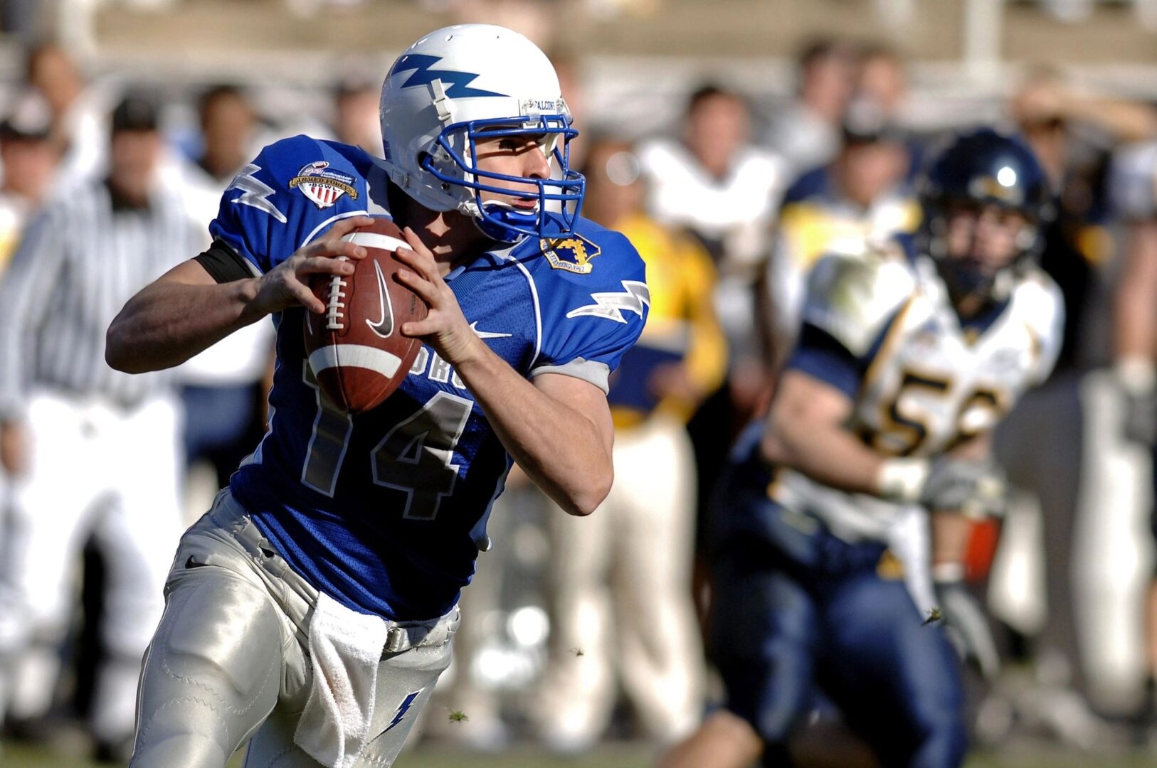 A football player is running with the ball.