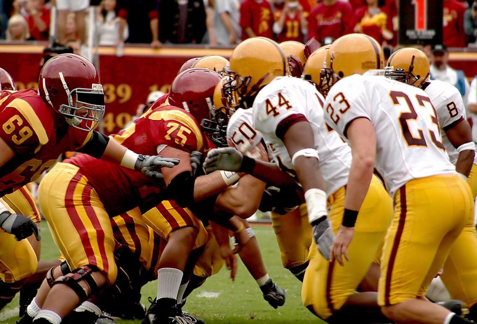 A group of men playing football on a field.